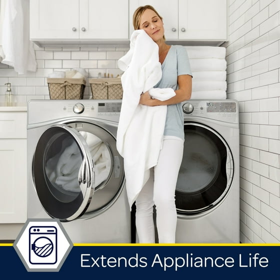 Woman holding white towels in a laundry room with washing machines, text 'Extends Appliance Life'.